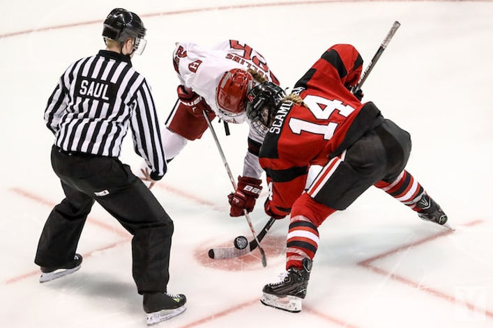 Hockey players fighting over a puck