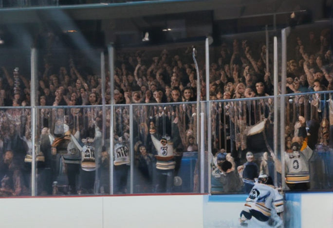Excited fans cheering while watching a hockey game